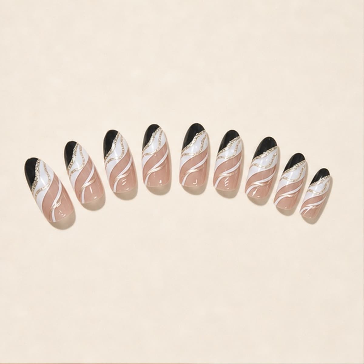 Minuit black-and-white ripple press-on nail set arranged in a fan on an ivory background