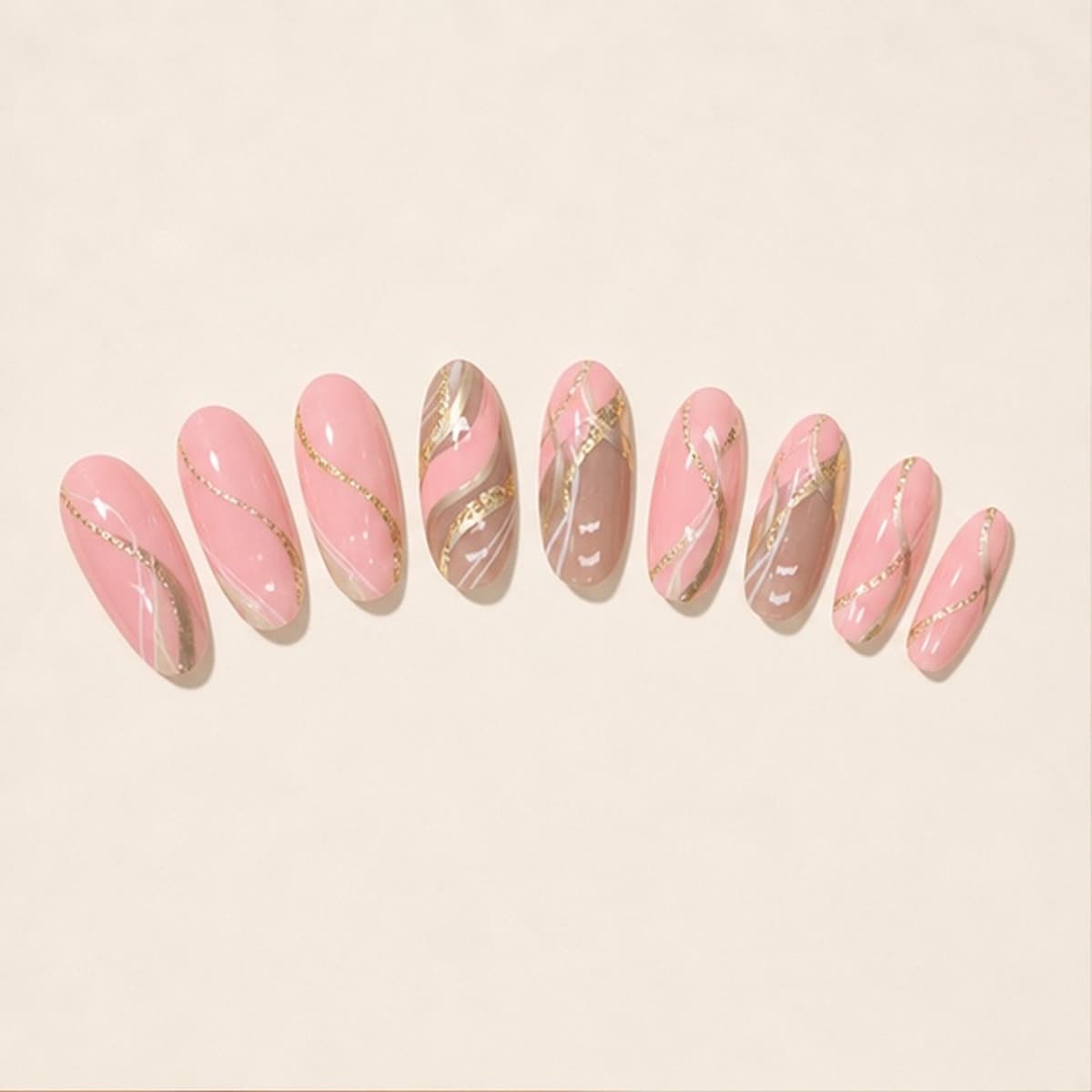 Velours pink and champagne ripple press-on nail set arranged in a fan on an ivory background