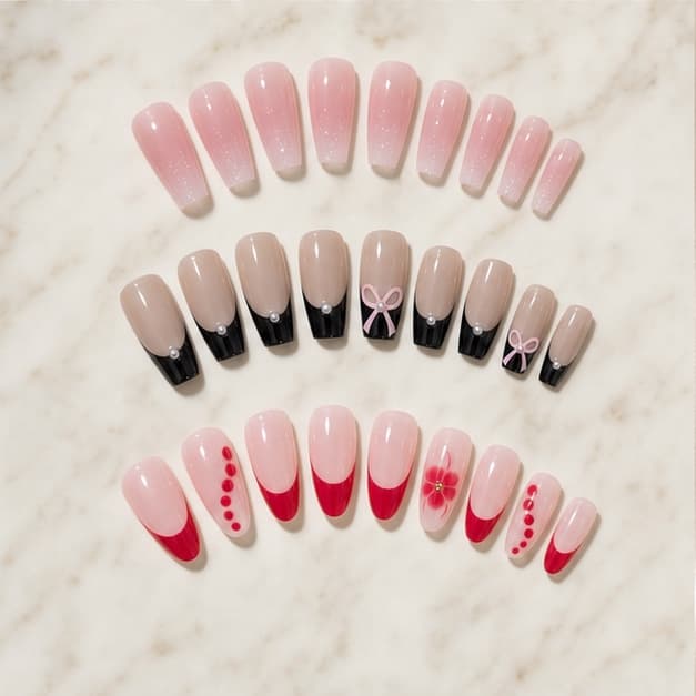 Nacre, Coquette and Rubis press-on nail sets arranged on pale marble